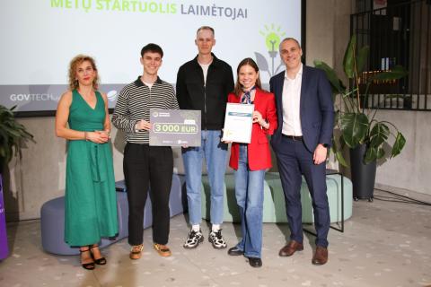 Žmonės stovi, laiko prizus